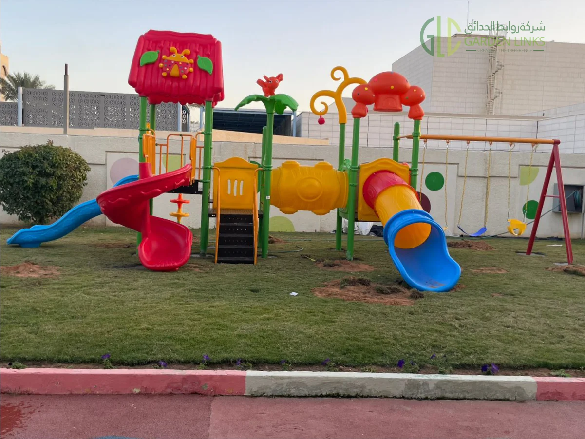 Completed school playground installation in Riyadh with slides, swings, safety flooring, and shaded play areas by Garden Links Company.