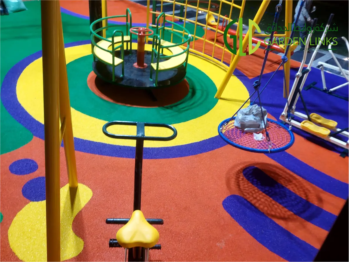 This image shows the completed Residential Outdoor Playground Installation in Al Qatif featuring swing systems, monkey bars, seesaw, rounders, and custom EPDM safety flooring installed by Garden Links Company.