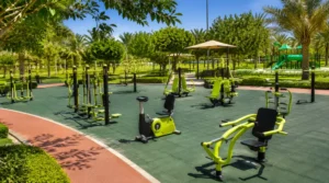 Outdoor gym equipment in a Saudi park showing cardio, strength, mobility, and bodyweight exercise stations