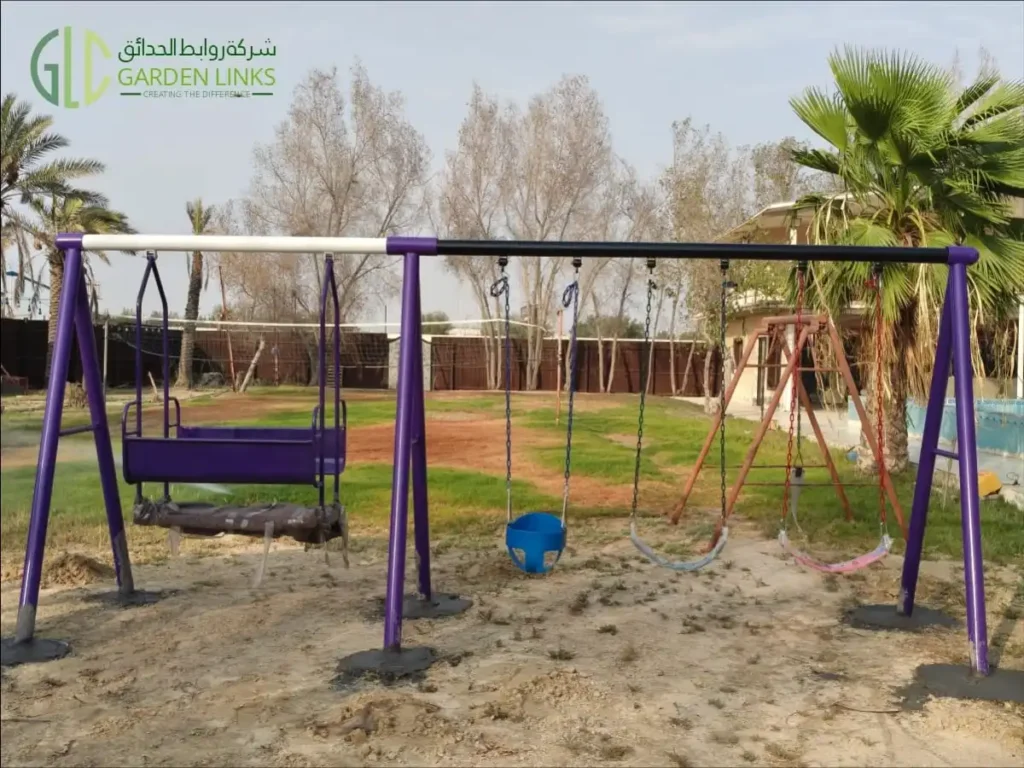 Commercial outdoor swing set installed in Dammam, Saudi Arabia, featuring an inclusive bench swing, toddler bucket swing, and belt swings by Garden Links.