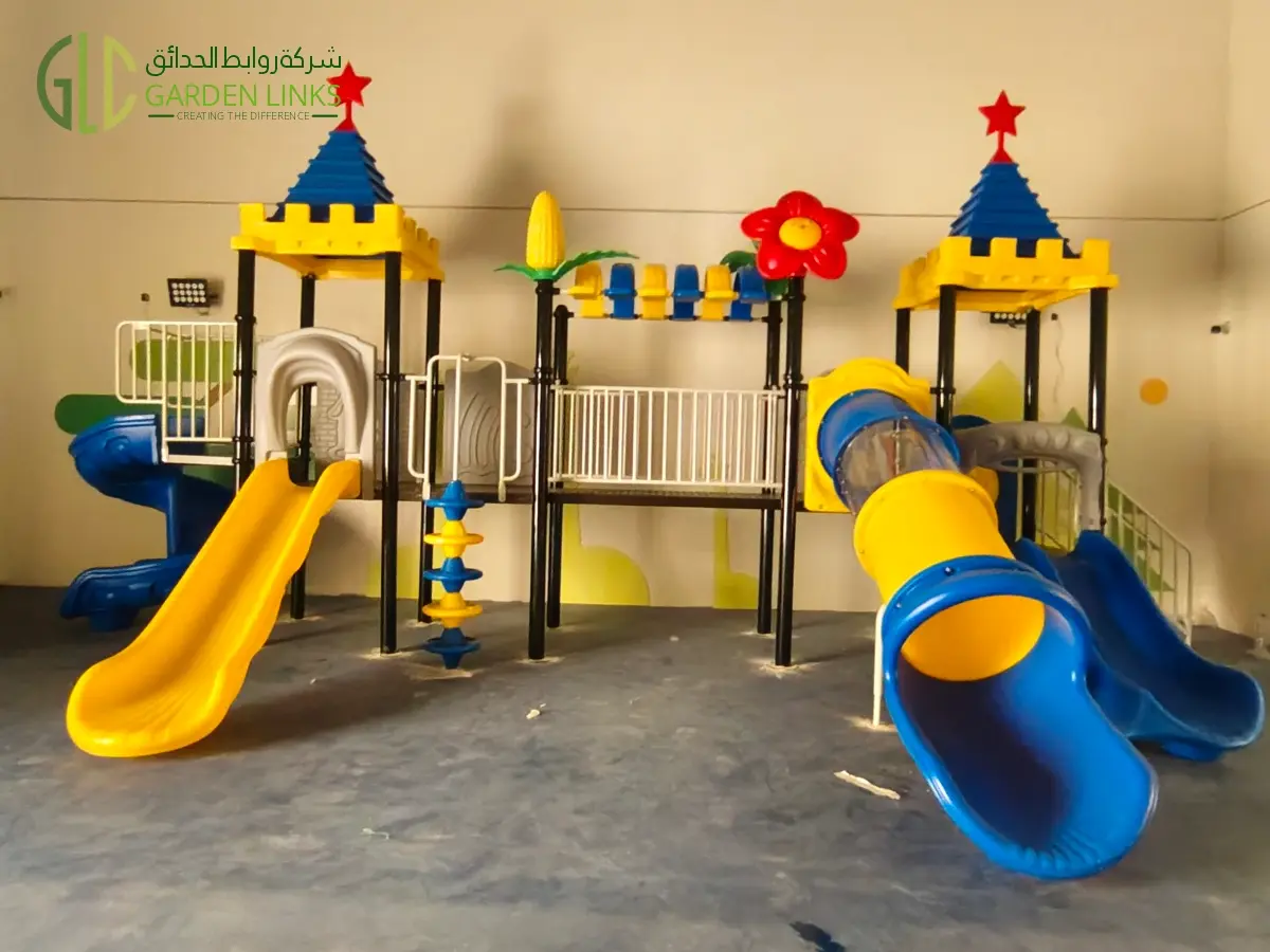 Commercial indoor playground equipment installed by Garden Links in Ishbiliyah, Riyadh, featuring a multi-play structure with straight slide, spiral tube slide, climbing activities, and child-safe play zones.