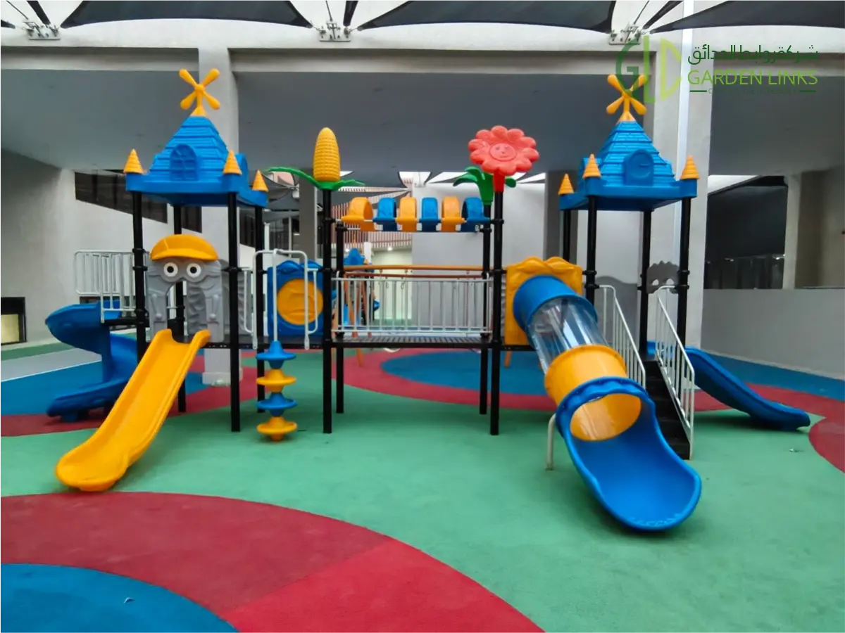 Playground equipment installation at Gheras School in Riyadh, Saudi Arabia featuring a commercial multi-play system with EPDM safety flooring, slides, and swings.