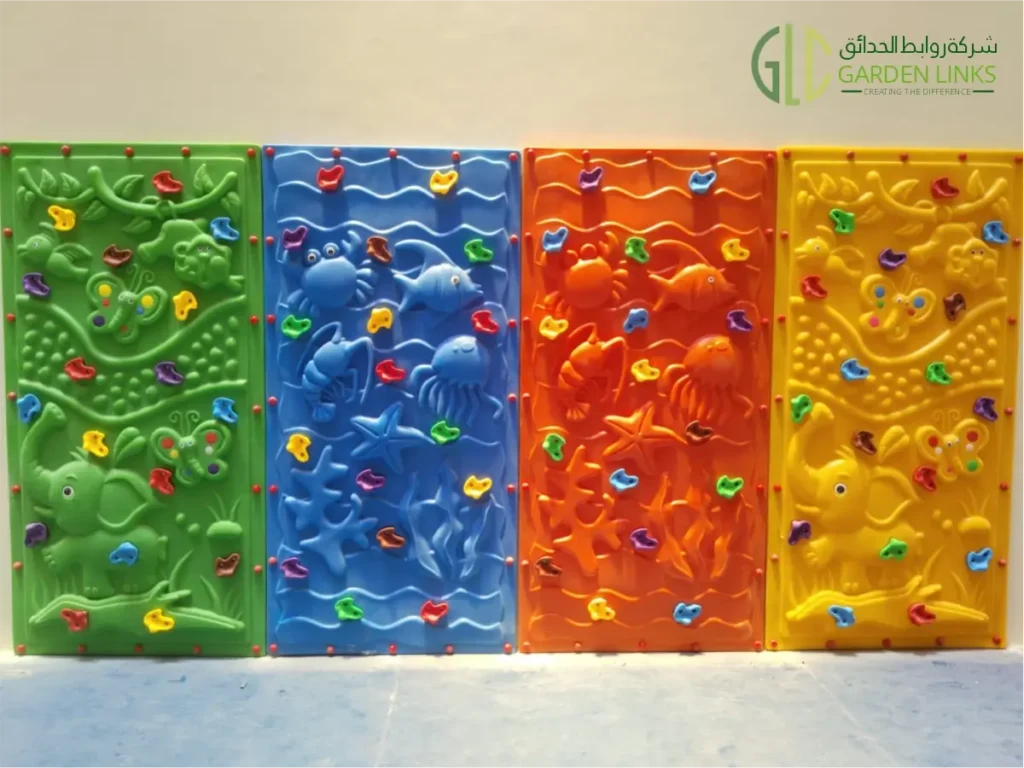 Colorful indoor playground climbing wall panels featuring nature, ocean, jungle, and animal-themed designs with multicolored climbing holds.
