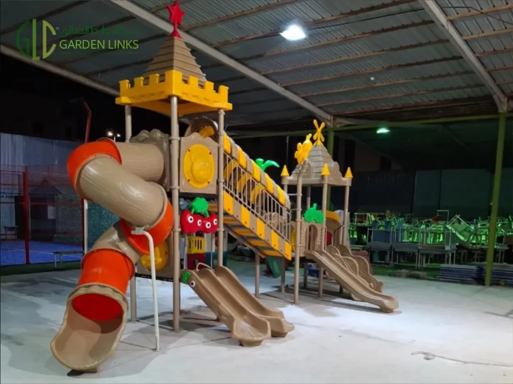 Outdoor playground equipment with tower slides and tunnel slide installed in Jeddah.