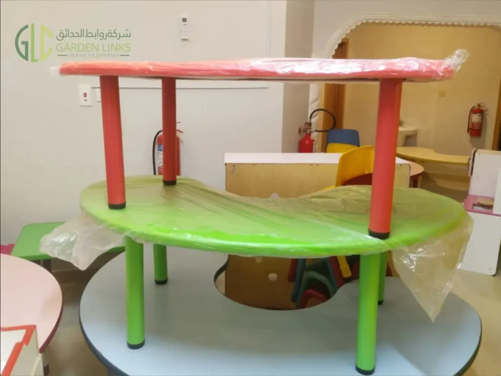 Colourful multi-level children’s activity table installed as part of an indoor school play area in Riyadh.