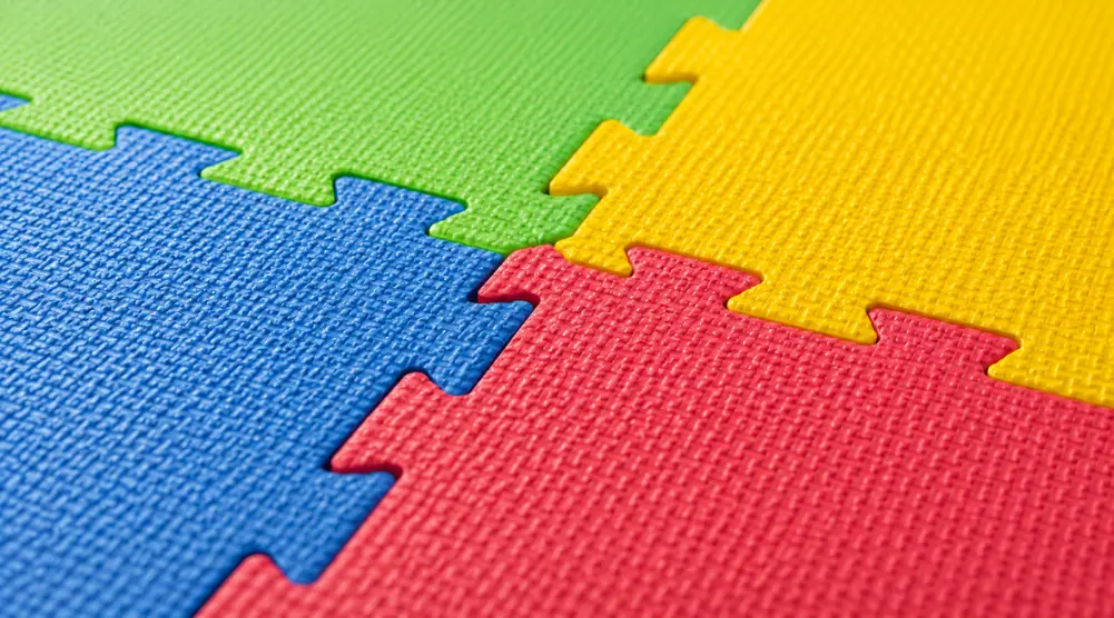 Indoor soft play flooring with colorful interlocking EVA foam tiles designed to provide a cushioned and safer surface for children.