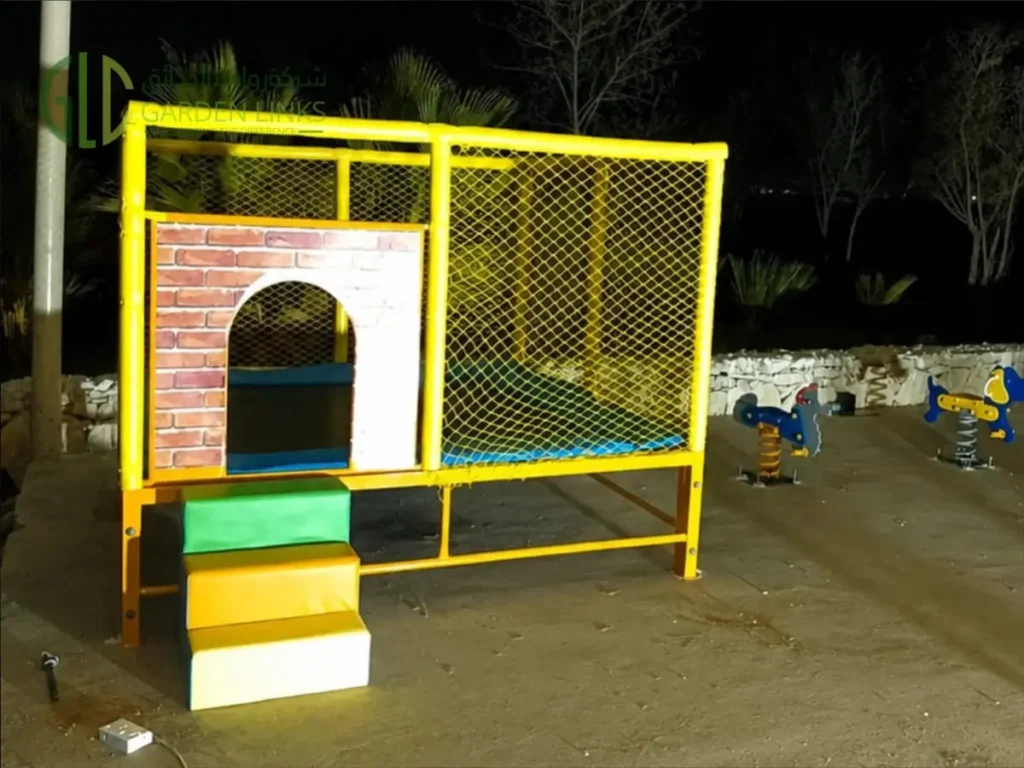 Enclosed trampoline play unit with soft steps and spring riders in Al Kharj playground.