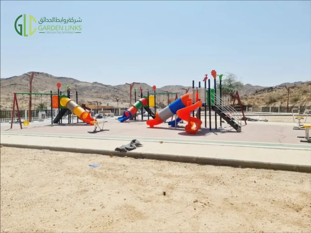 Children’s playground equipment with multiple slides and swings installed in a public park in Taala, Saudi Arabia.