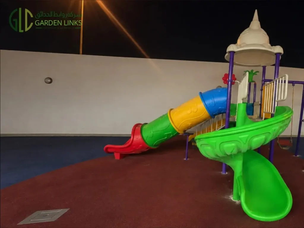 Kindergarten playground installation in Riyadh with enclosed tube slide, spiral slide, elevated platform and rubber safety flooring in Al Yasmin.