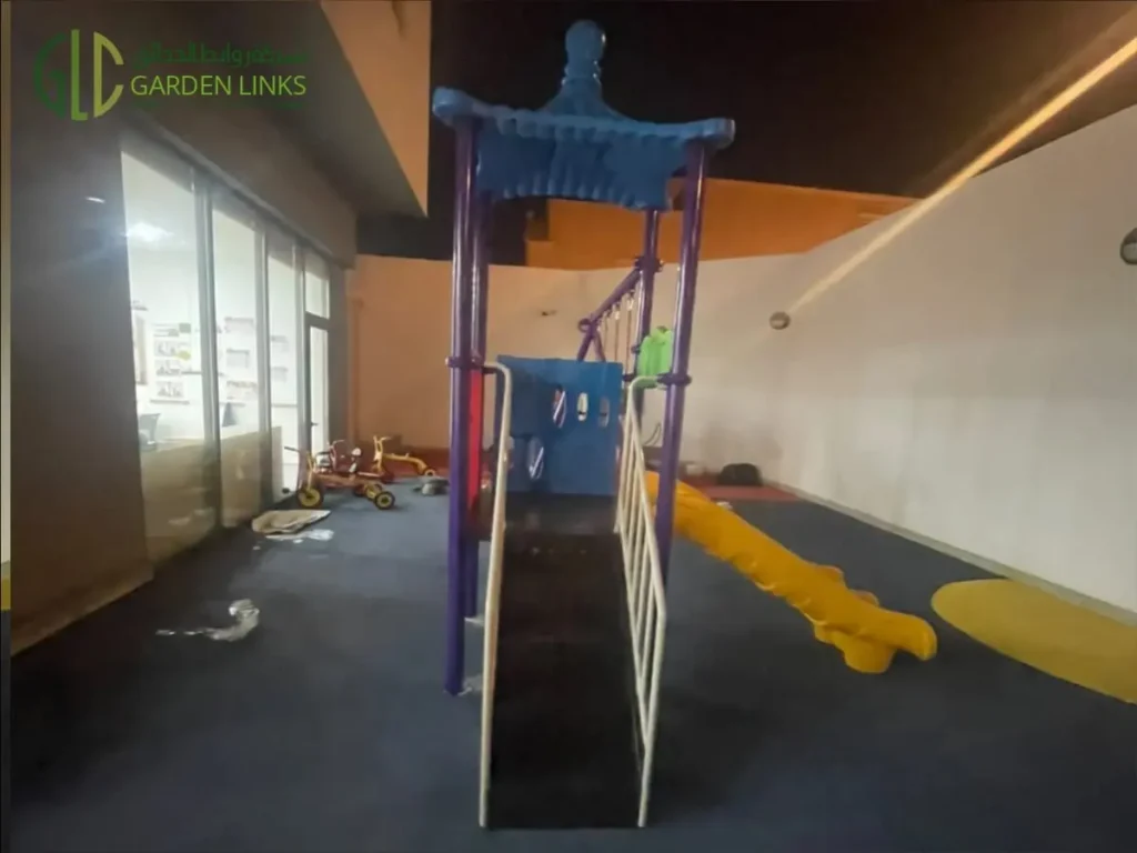 Kindergarten playground installation in Riyadh with access stairs, elevated play platform, slide and rubber safety flooring in Al Yasmin.