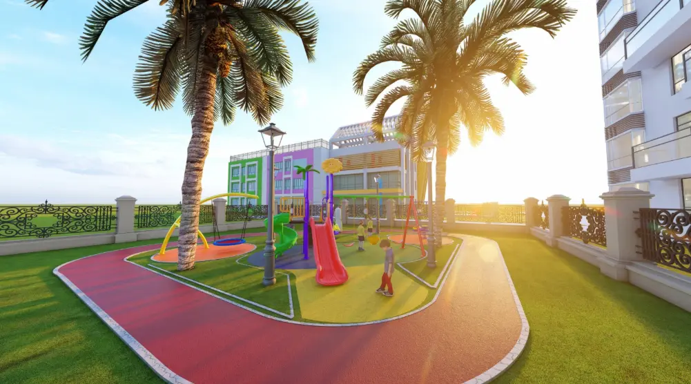 Outdoor residential playground with a straight slide, spiral slide, swings, basket swing and colorful safety flooring between palm trees
