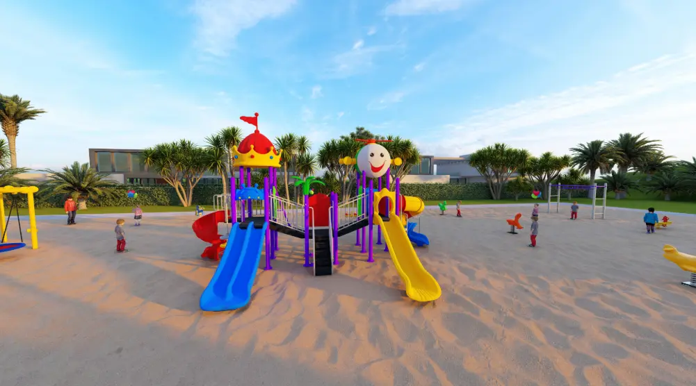 Front view of themed playground towers with a red decorative roof, smiling panel and blue and yellow slides