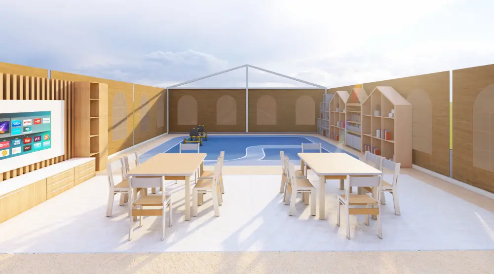 Children’s learning area with two tables, chairs, a wall activity panel, shelving and a blue play zone