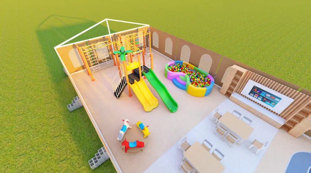 Elevated view of a children’s play area with yellow and green slides, climbing equipment, a ball pool and activity tables