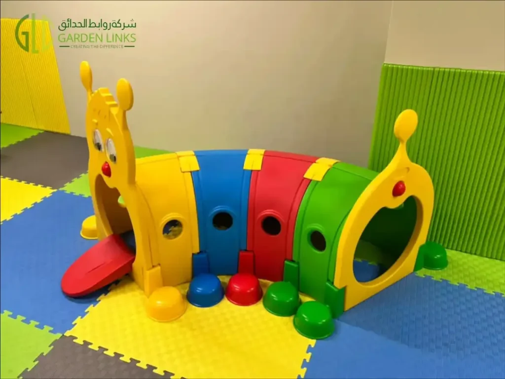 Colorful children’s crawl-through tunnel with yellow end panels on indoor foam flooring.