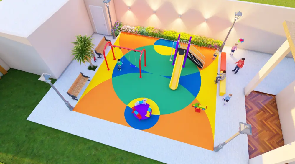 Angled aerial view of a square courtyard play area with a yellow slide, swings, roundabout and colorful circular flooring