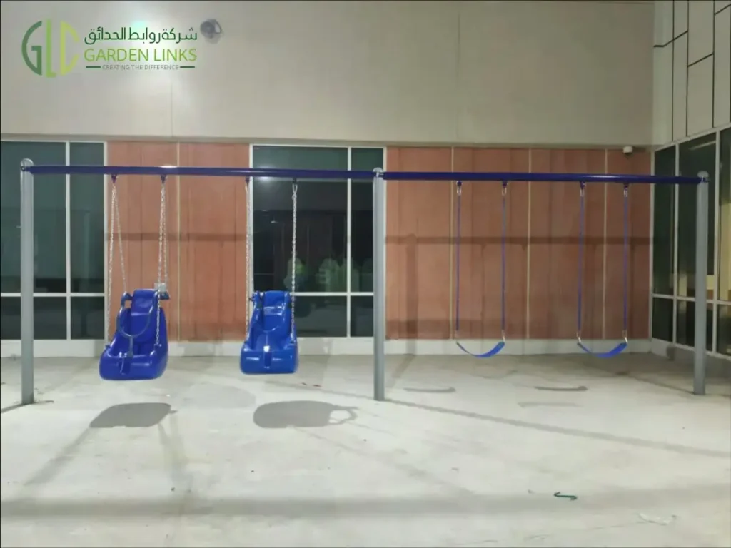 Aramco School Playground Al Ahsa four-seat swing frame with two blue supported seats and two belt-style seats.