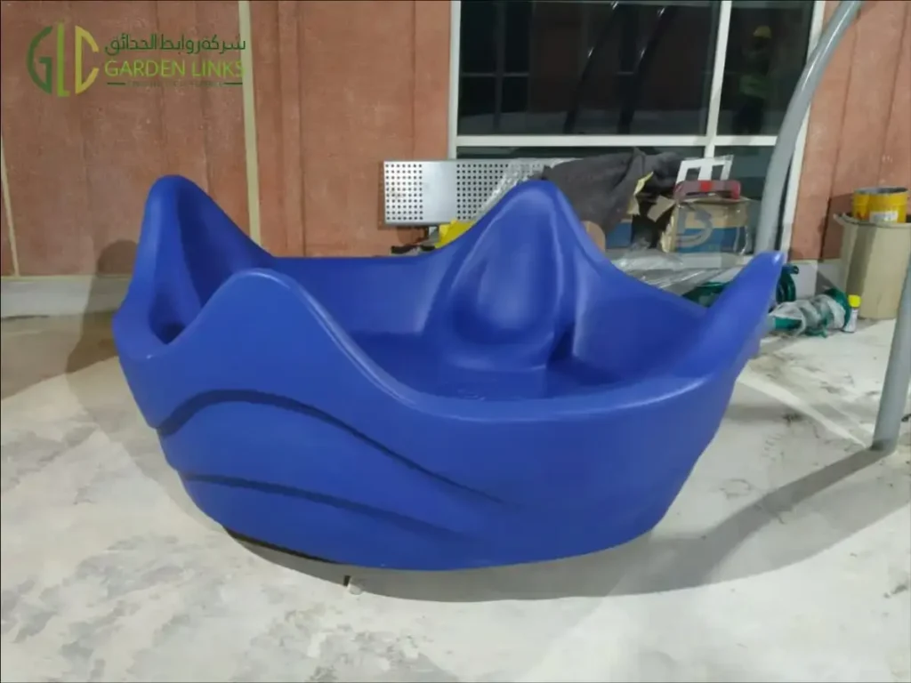 Aramco School Playground Al Ahsa blue bowl-shaped component with sculpted contours, photographed during installation.