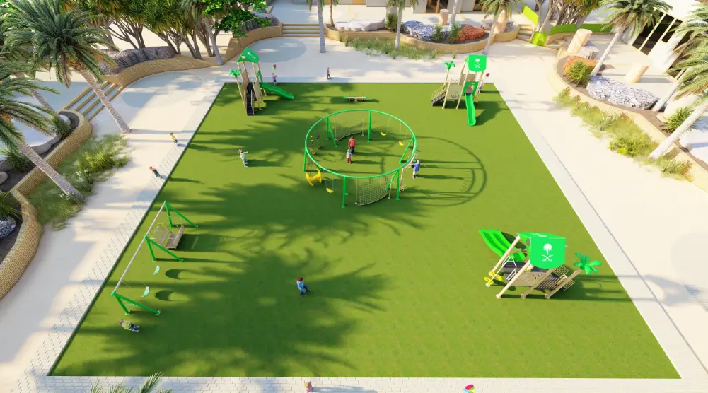 Wide elevated view of a green play park with swings, a circular activity frame and slide towers surrounded by palms