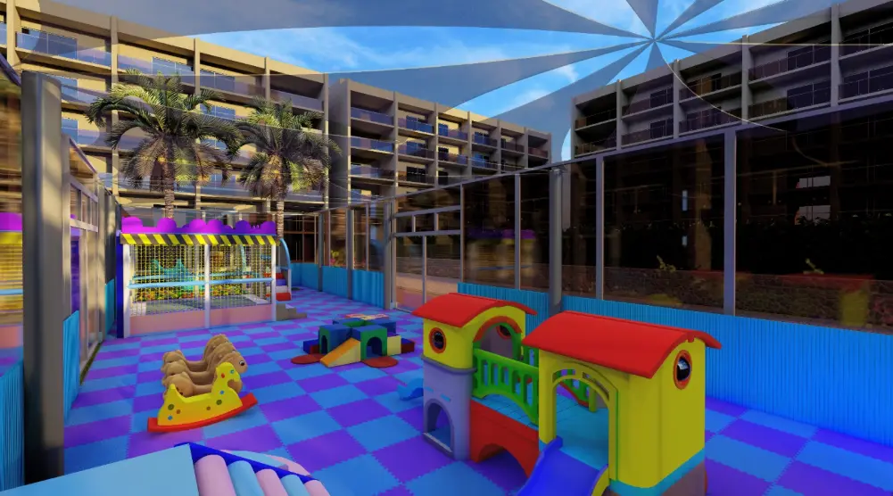 Colourful playhouses and rocking toys with a netted soft play structure at the opposite end of a courtyard