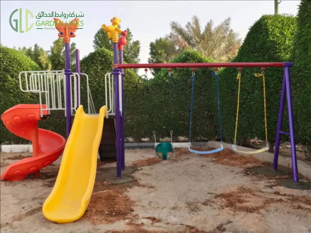 Three-swing playset installation in Quba with a green bucket seat, two open swing seats, a yellow straight slide and a red spiral slide.